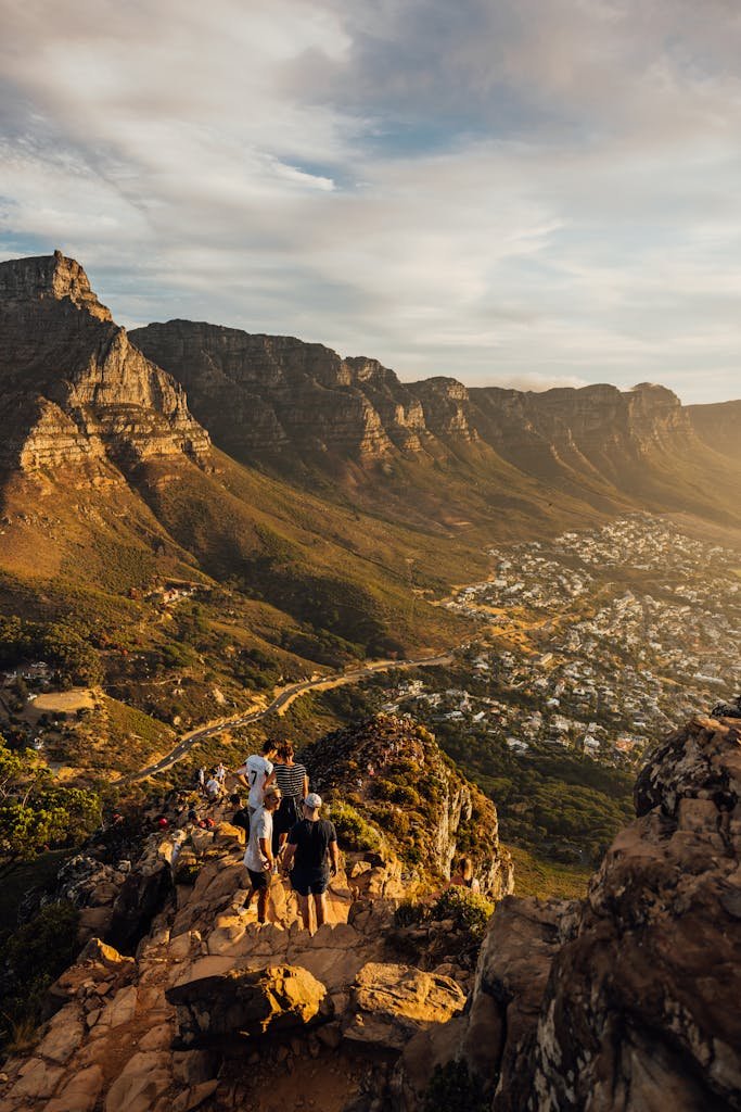 A breathtaking sunset view from Lion's Head with hikers enjoying the scenic landscape in Cape Town.