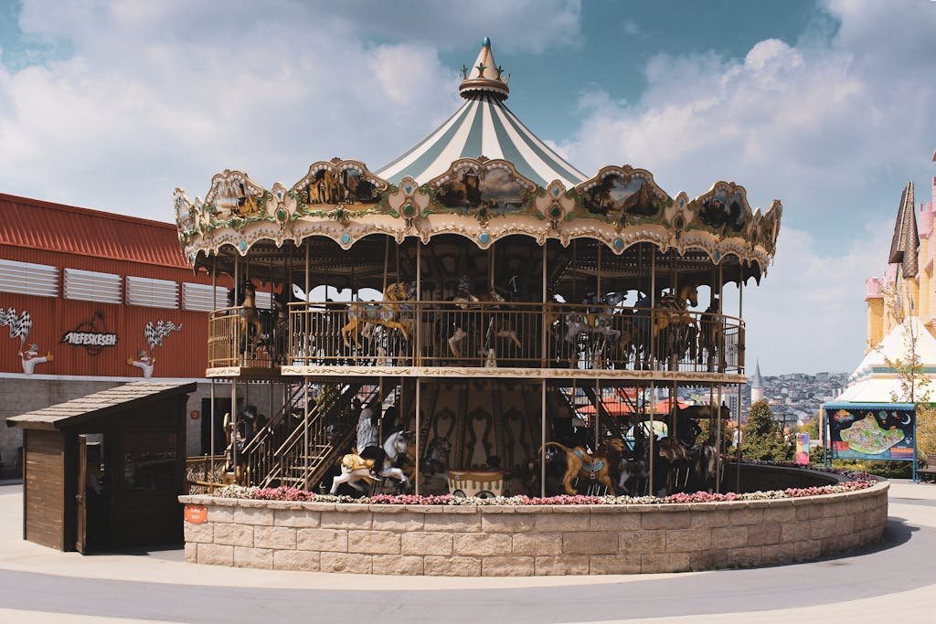 A classic carousel in a vibrant amusement park setting in Eyüp, İstanbul, Turkey, showcasing fun and excitement.