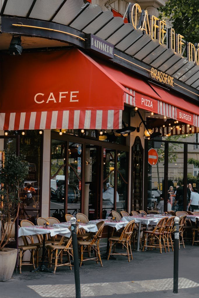 A picturesque Parisian café terrace with empty tables ready for customers.