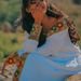 A smiling Ethiopian woman in traditional attire enjoying a sunny day outdoors, captured in Addis Ababa.