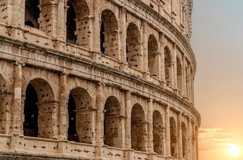 A stunning view of the Roman Colosseum at sunset, capturing the essence of historic Rome.