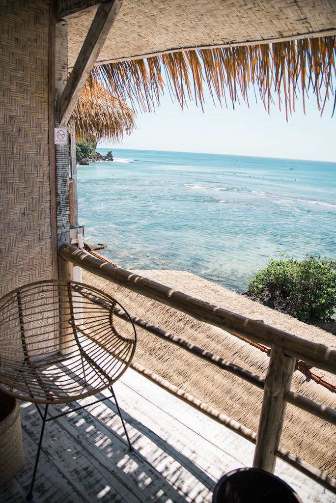 A wooden balcony with a view of the tranquil sea, ideal for relaxation in summer.