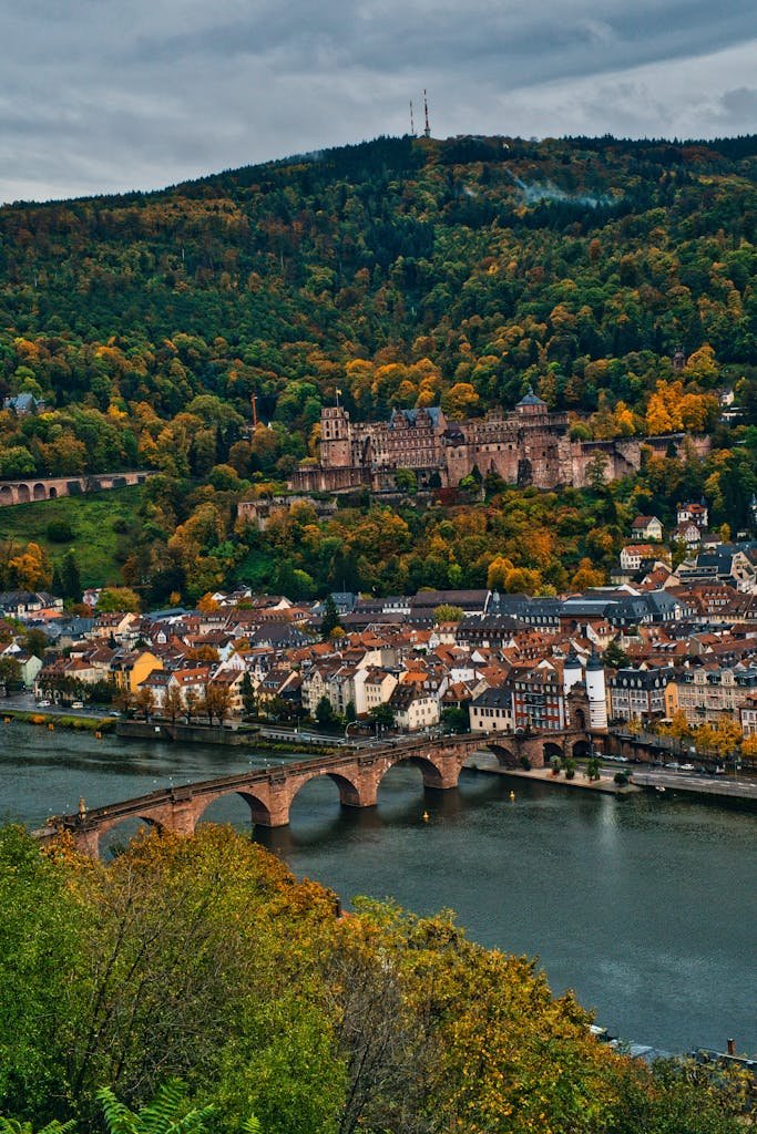 Captivating view of Heidelberg Castle and the Old Bridge over the Neckar River in autumn.