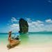 Capture the serene beauty of a Thailand beach with turquoise waters and iconic rock formations.