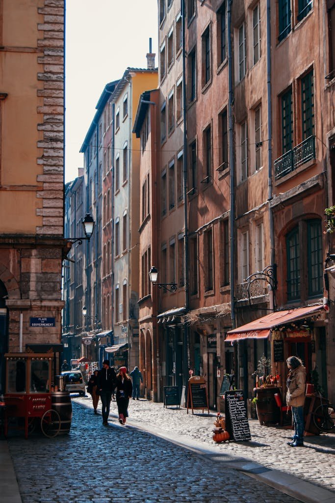 Charming street in Lyon's old town with cobblestones and historic buildings on a sunny day.