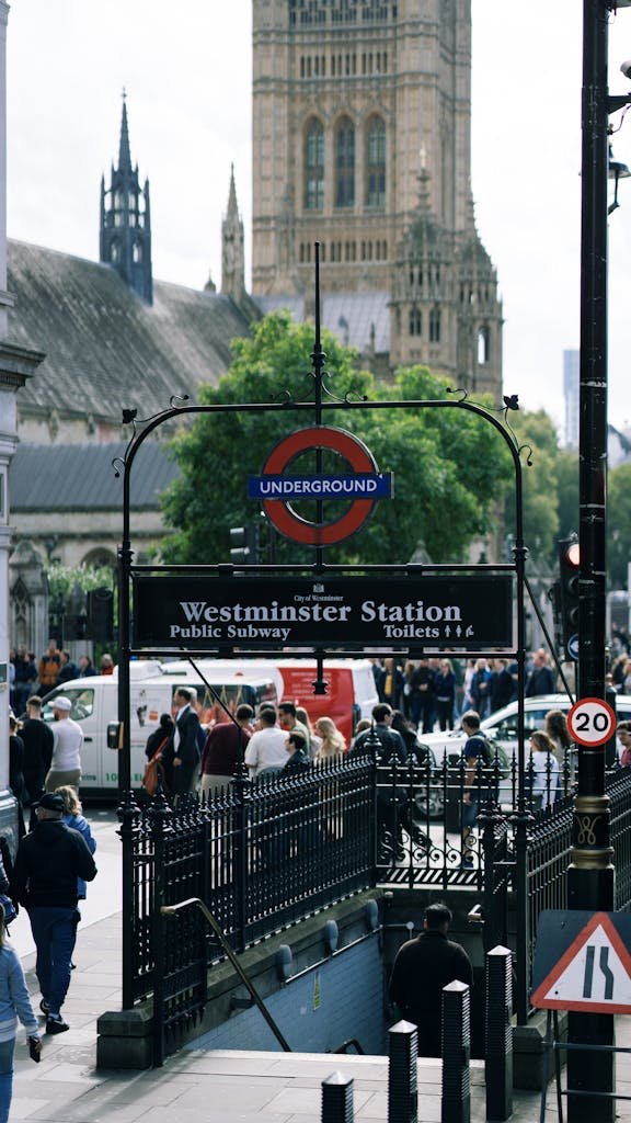 Crowds gather at Westminster Underground Station with iconic Big Ben in the backdrop.