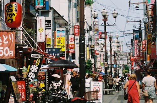 Explore the bustling atmosphere of a vibrant street in Japan, displaying daily life and local culture.