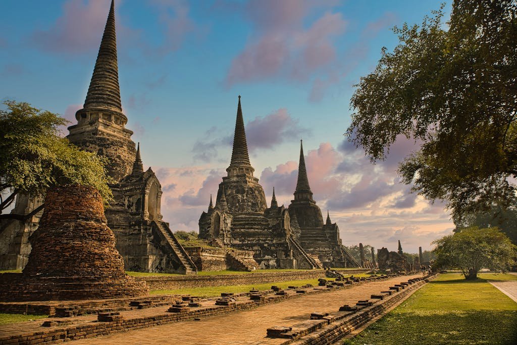 Explore the stunning ancient temples of Ayutthaya in Thailand, showcasing historical architecture and serene beauty at sunset.