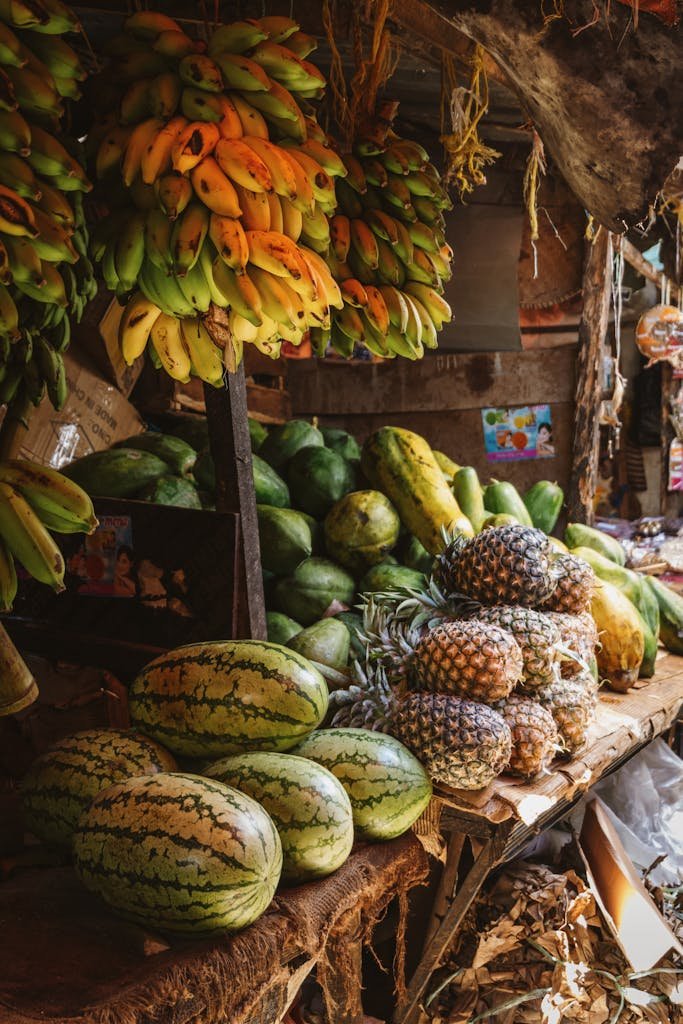 Fresh tropical fruits displayed at a vibrant market stall in Zanzibar, Tanzania.