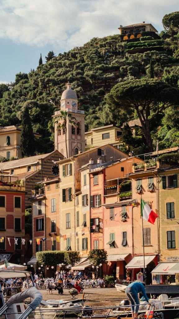 Picturesque view of Portofino harbor with colorful buildings and lush hillsides in Liguria, Italy.