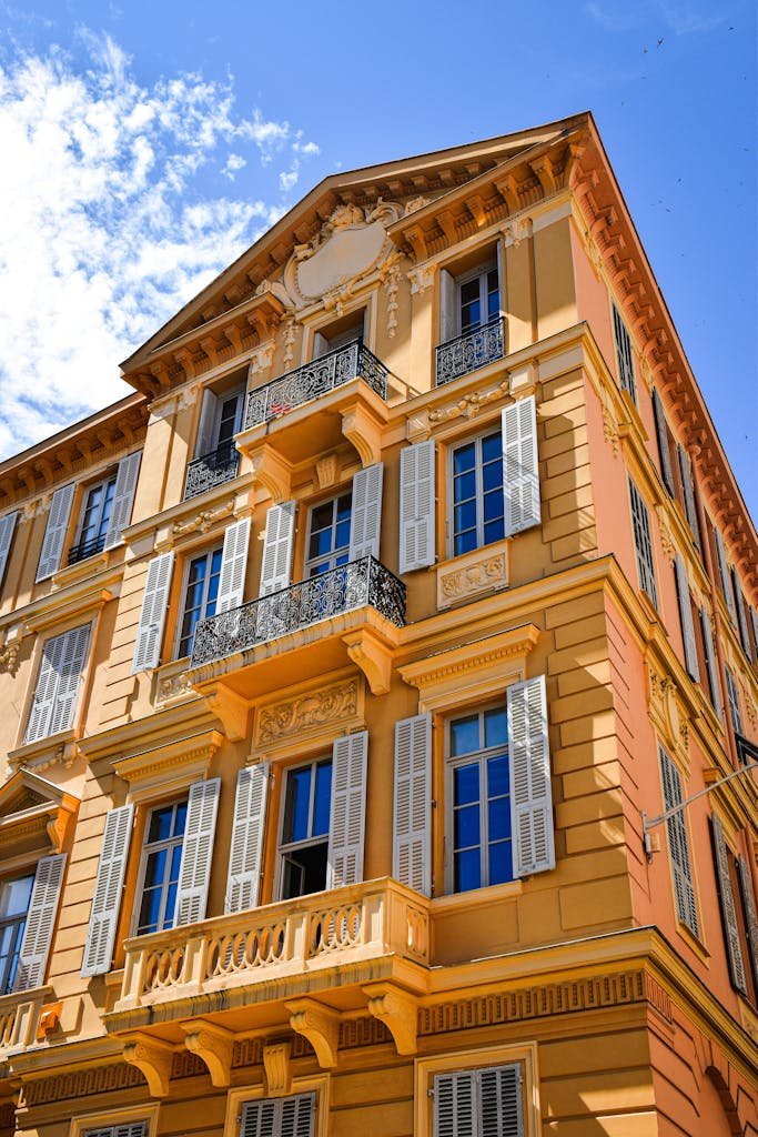 Stunning classical architecture with ornate details in Nice, France under a clear blue sky.