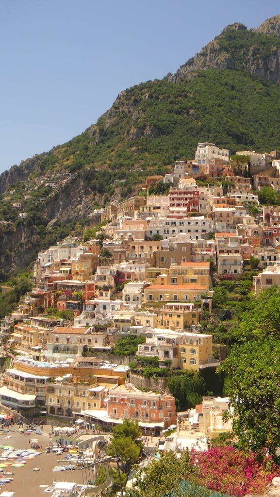 Stunning hillside view of the colorful houses of Positano on the Amalfi Coast under a clear blue sky.