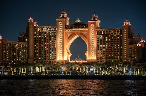 Stunning night view of Atlantis The Palm hotel in Dubai, UAE, glowing with warm lights.