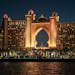 Stunning night view of Atlantis The Palm hotel in Dubai, UAE, glowing with warm lights.