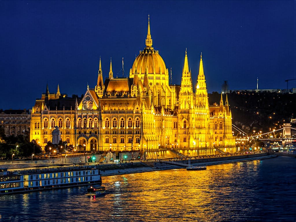 Stunning night view of the Budapest Parliament lit up beside the Danube River.