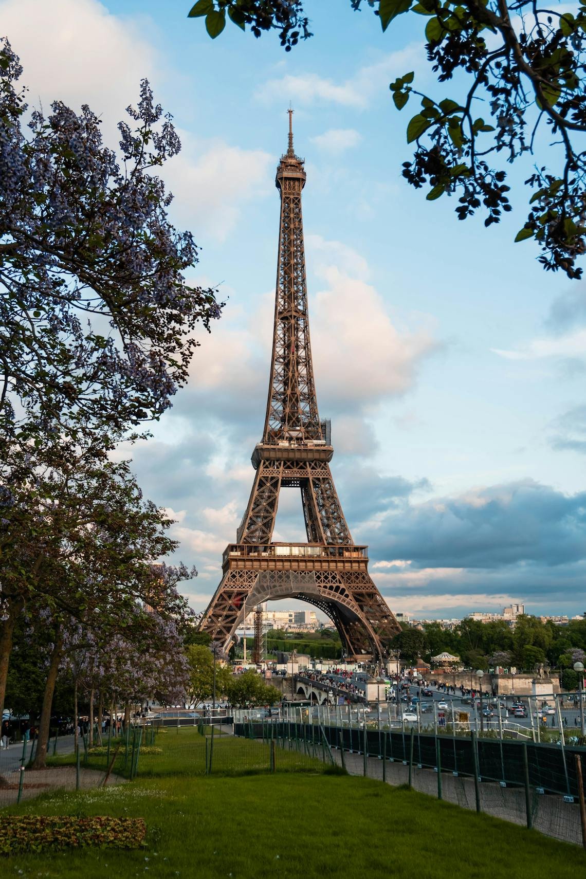 The iconic Eiffel Tower seen through blooming trees on a lovely spring day in Paris.
