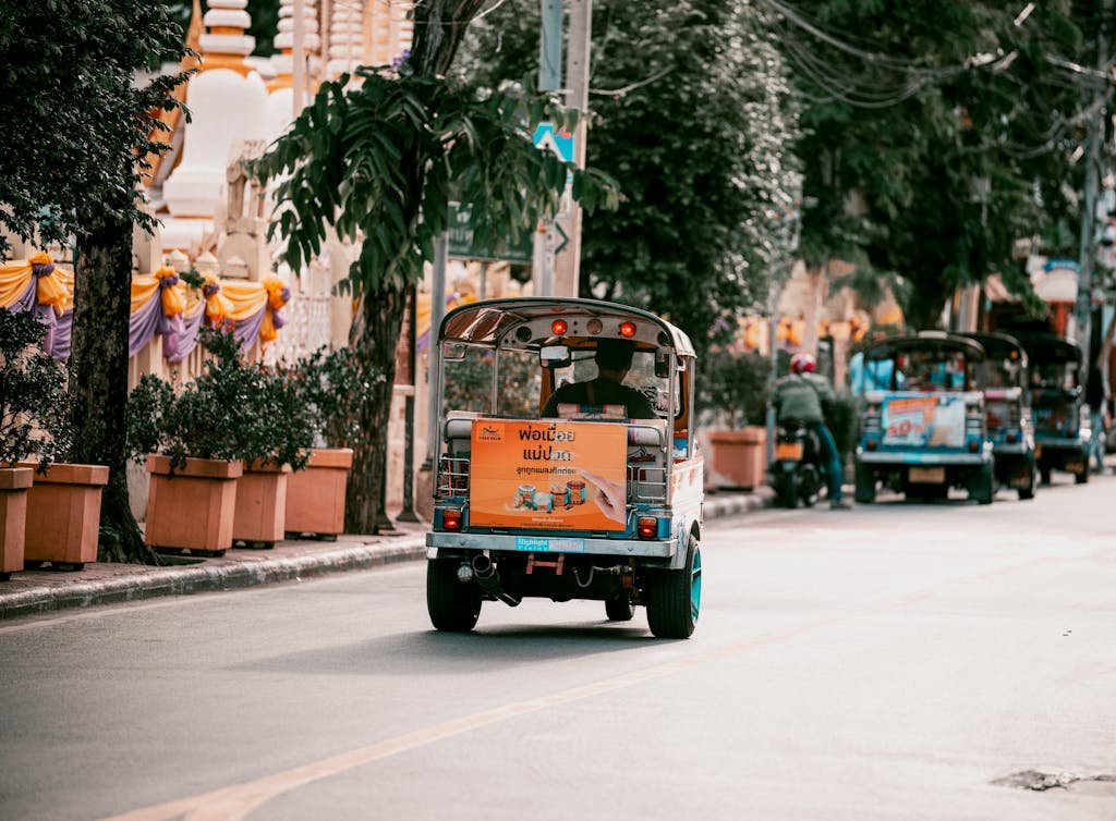 Vibrant Bangkok street filled with colorful tuk tuks showcasing urban transportation in Thailand.