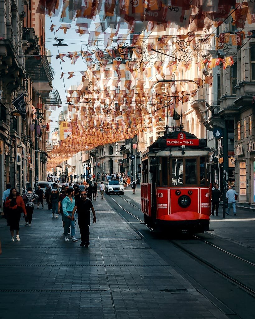 Vibrant Istanbul street scene featuring a classic red tram surrounded by busy urban life.