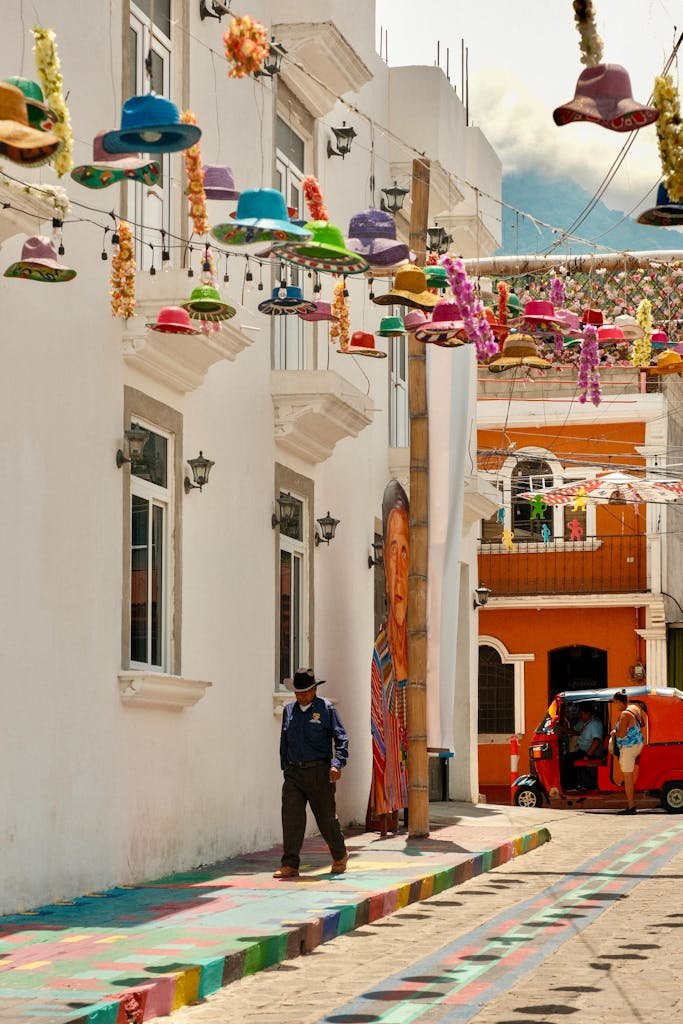 Vibrant street with hanging hats in Sololá, Guatemala, showcasing local culture.