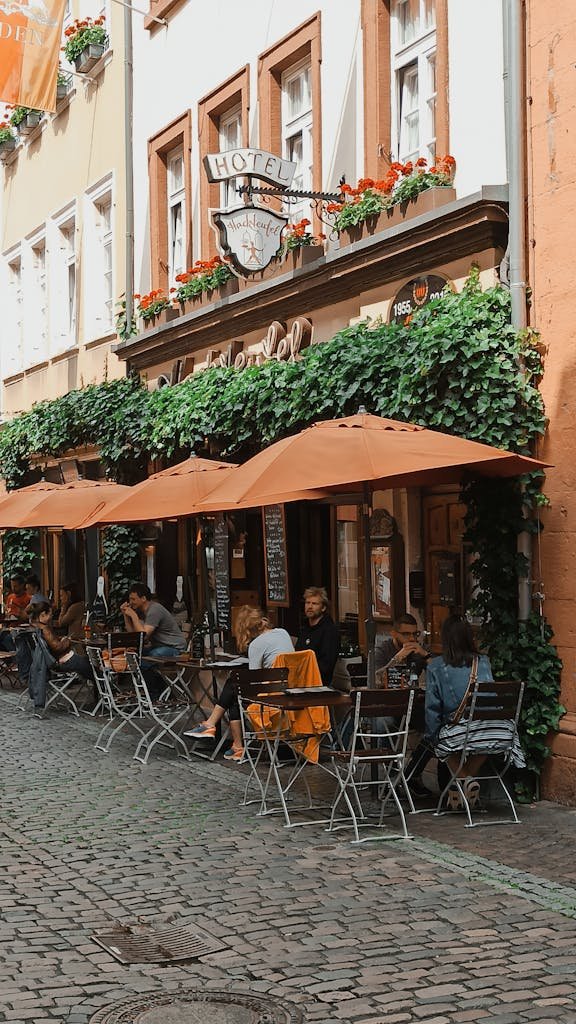 Quaint outdoor café in Heidelberg's Old Town, perfect for relaxing and enjoying a vibrant street atmosphere.
